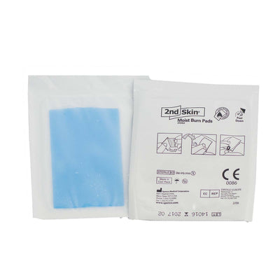 2nd Skin Burn Dressing shown with transparent blue gel pad and white medical packaging featuring instructional icons and product information for wound protection and burn treatment.